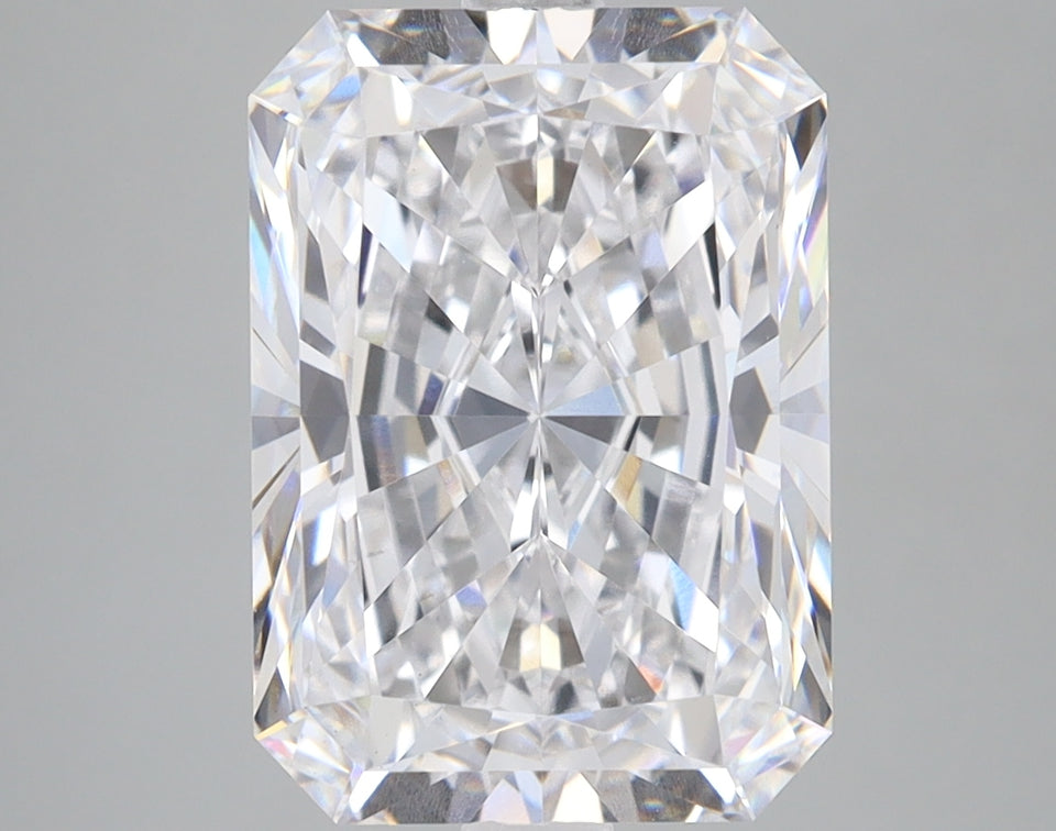 Radiant cut lab grown diamond with faceted surfaces reflecting light, displayed against neutral gray background.