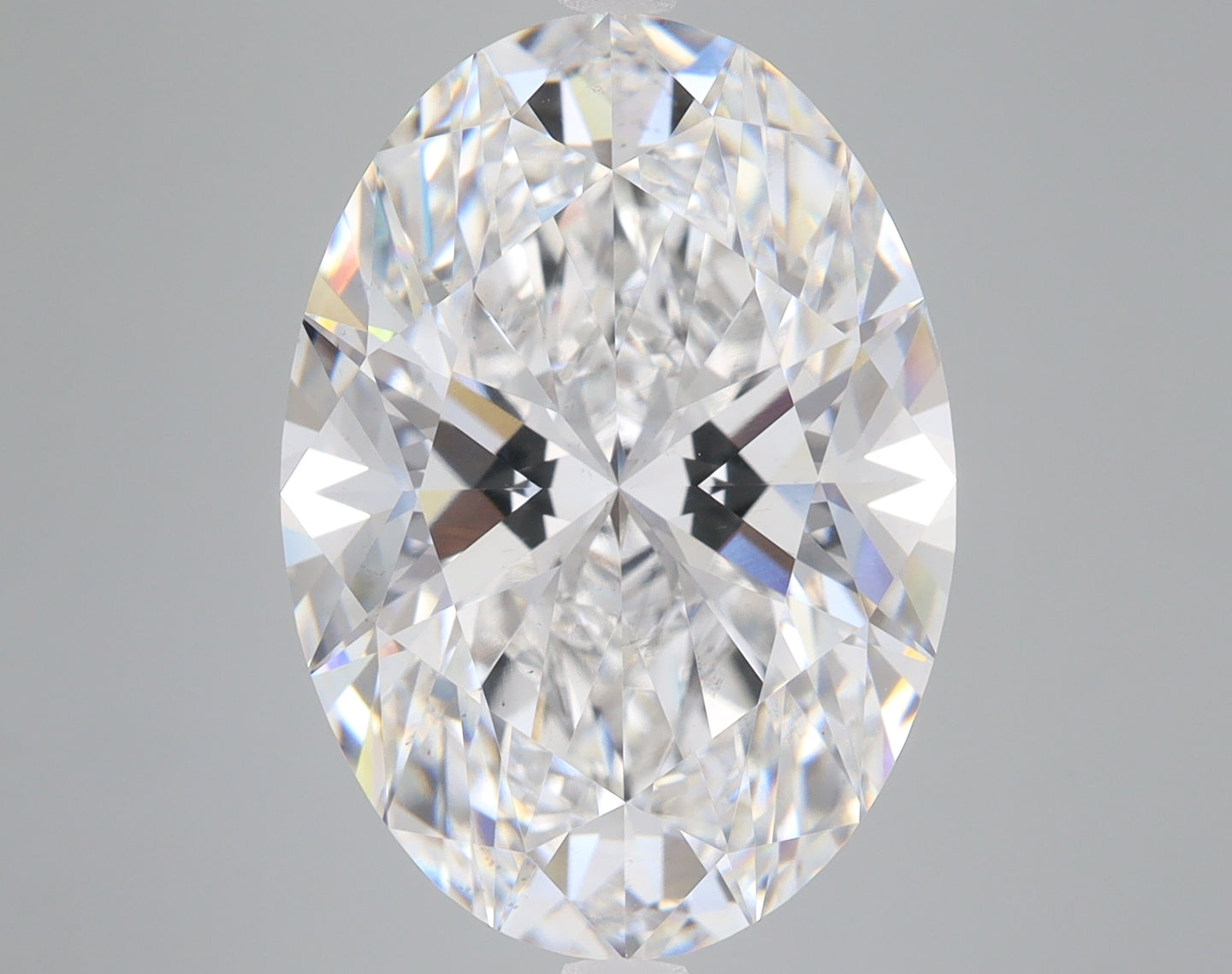 Oval-cut lab-grown diamond with faceted surfaces reflecting light, displayed against a neutral background.