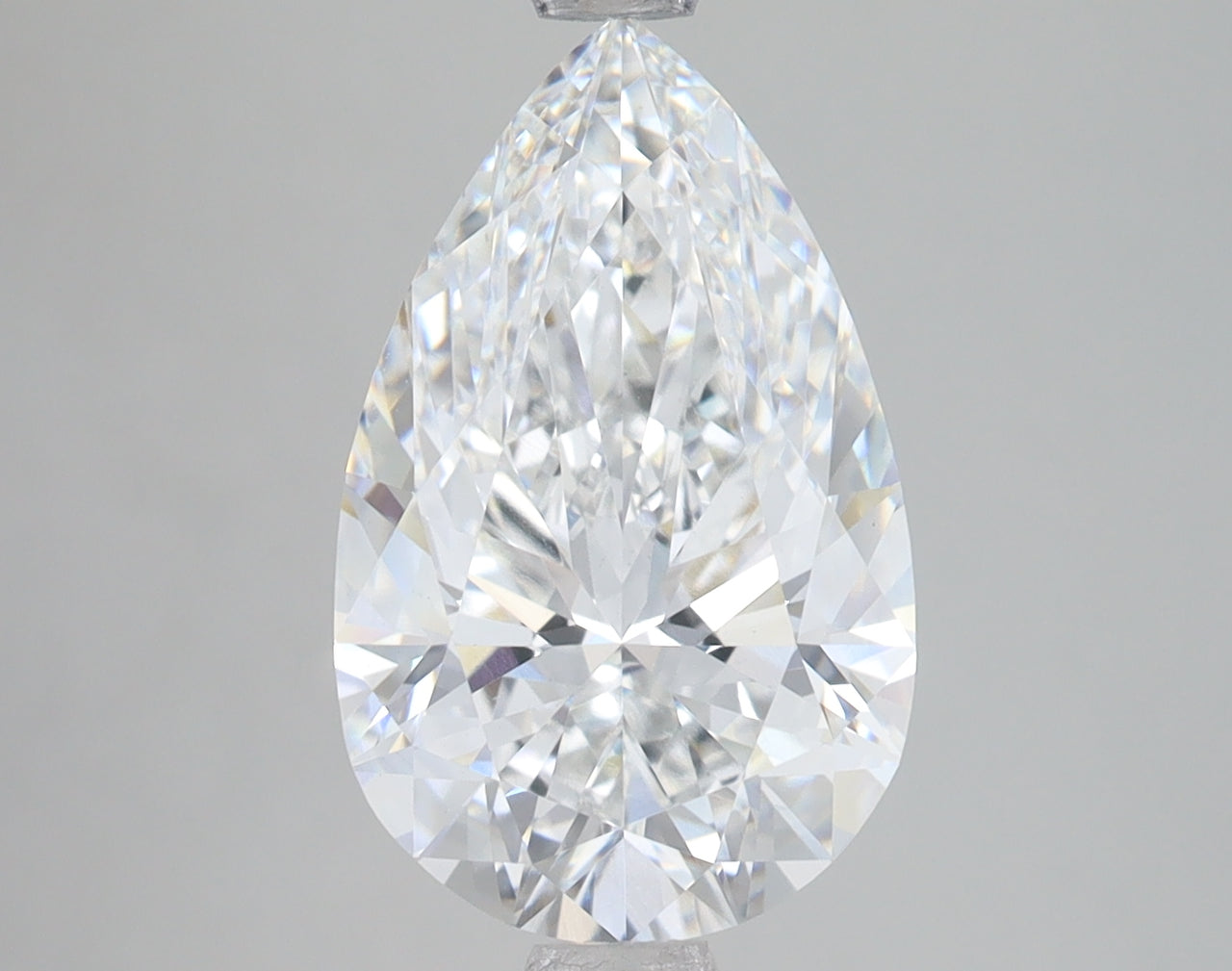 Pear-shaped lab-grown diamond with faceted surface and brilliant light refraction on neutral background.