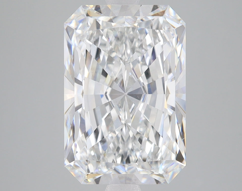 Radiant cut lab grown diamond with faceted surface reflecting light, displayed against neutral gray background.