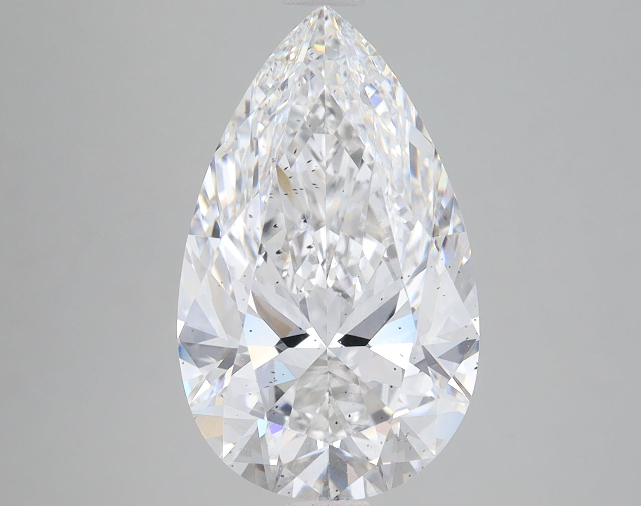 Pear-shaped lab-grown diamond with faceted surface and clear appearance, displayed against a neutral gray background.