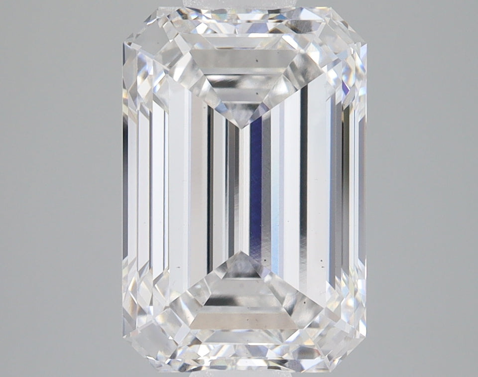 Emerald cut lab grown diamond with faceted sides and clear transparency, displayed against neutral background.