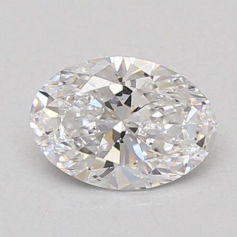 Oval-cut lab-grown diamond with faceted surfaces reflecting light, displayed on neutral background.