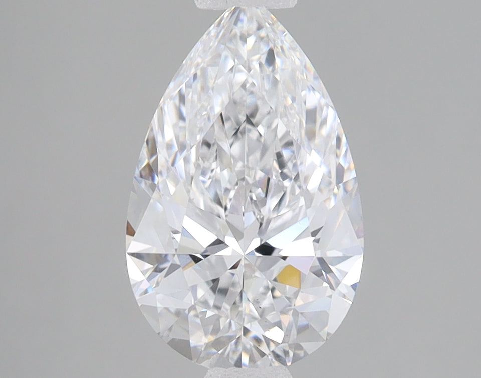 Pear-shaped lab-grown diamond with brilliant faceting and light reflections on gray background.