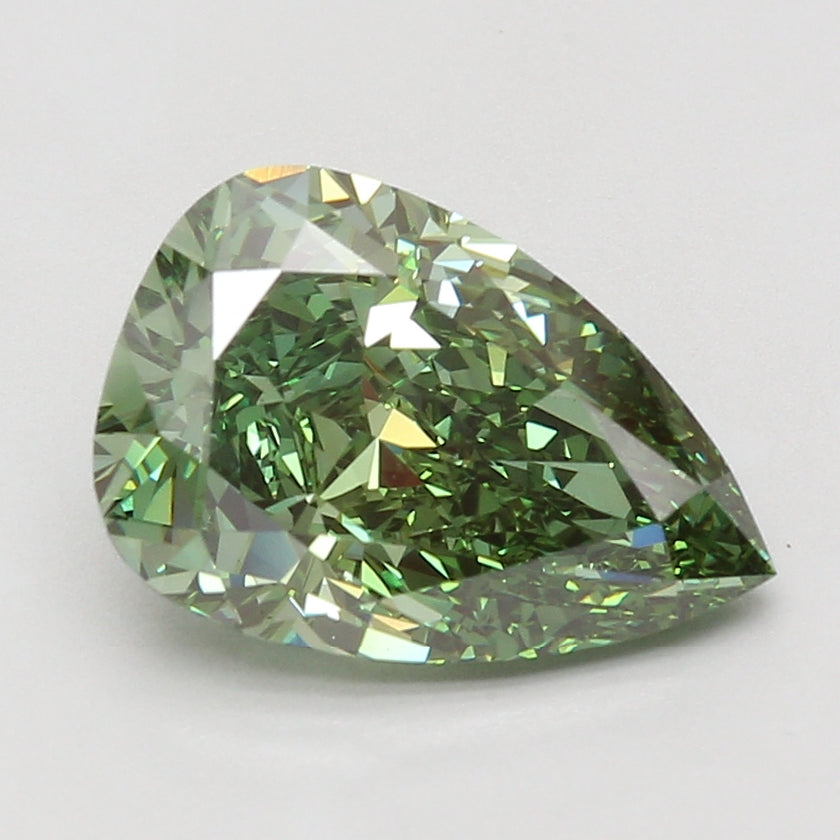 Pear-shaped lab-grown diamond with faceted surfaces reflecting light, displaying pale green to yellow tones.
