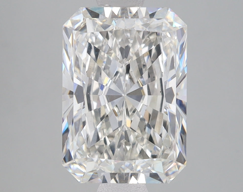 Radiant cut lab-grown diamond with clear faceting and light refraction on gray background.