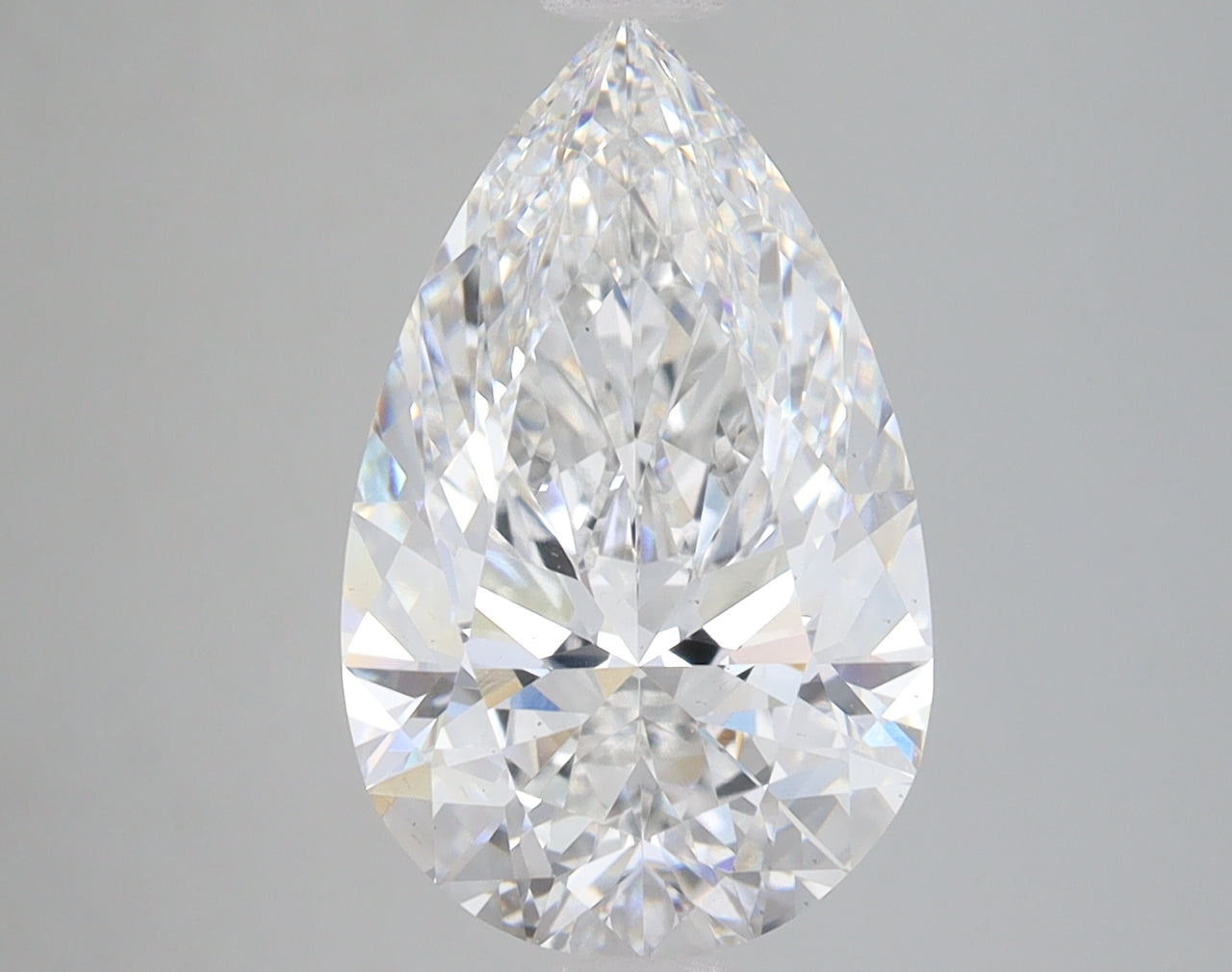 Pear-shaped colorless lab grown diamond with faceted surfaces and light reflections on gray background.