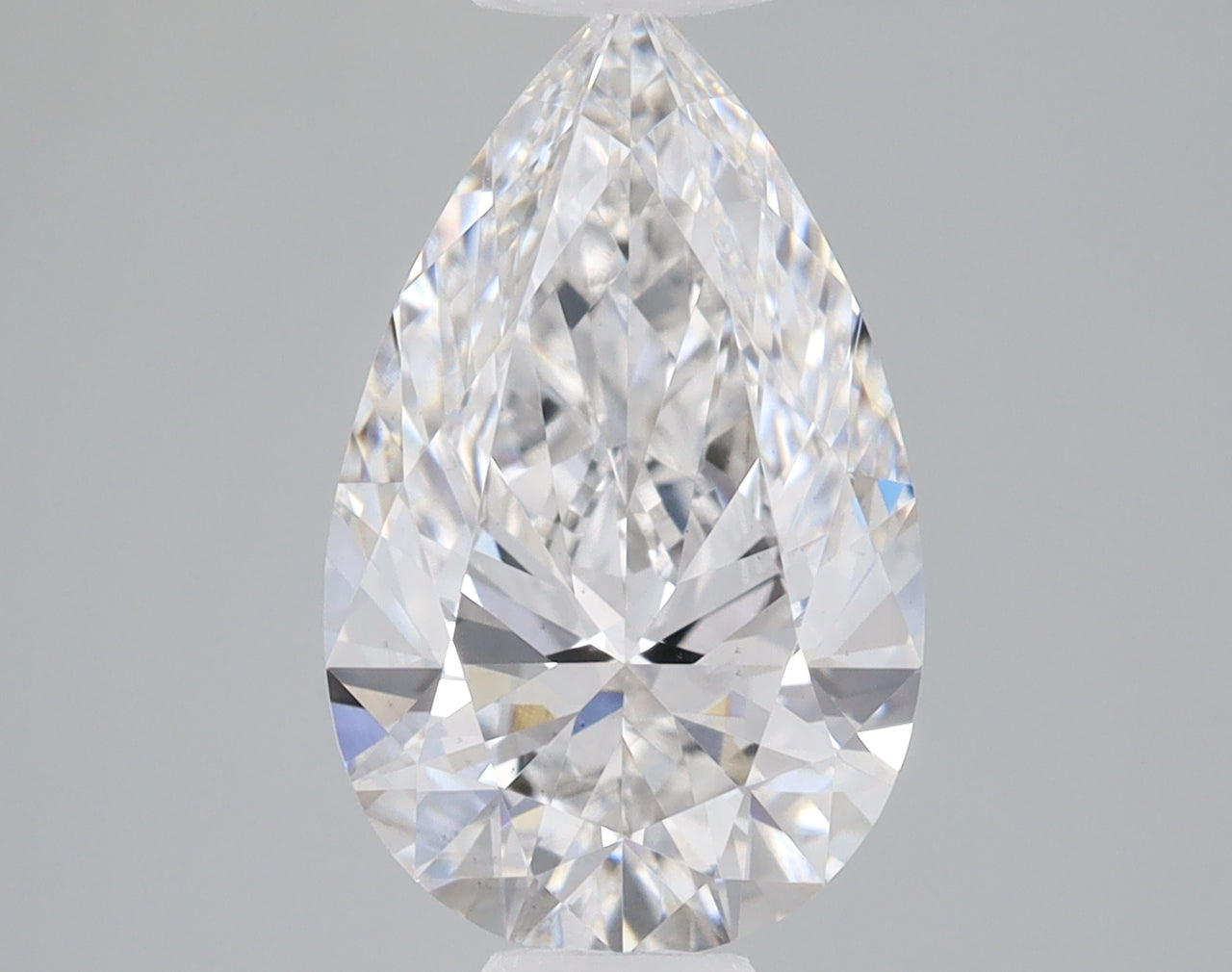 Pear-shaped clear lab-grown diamond with faceted surface and light reflections on neutral gray background.