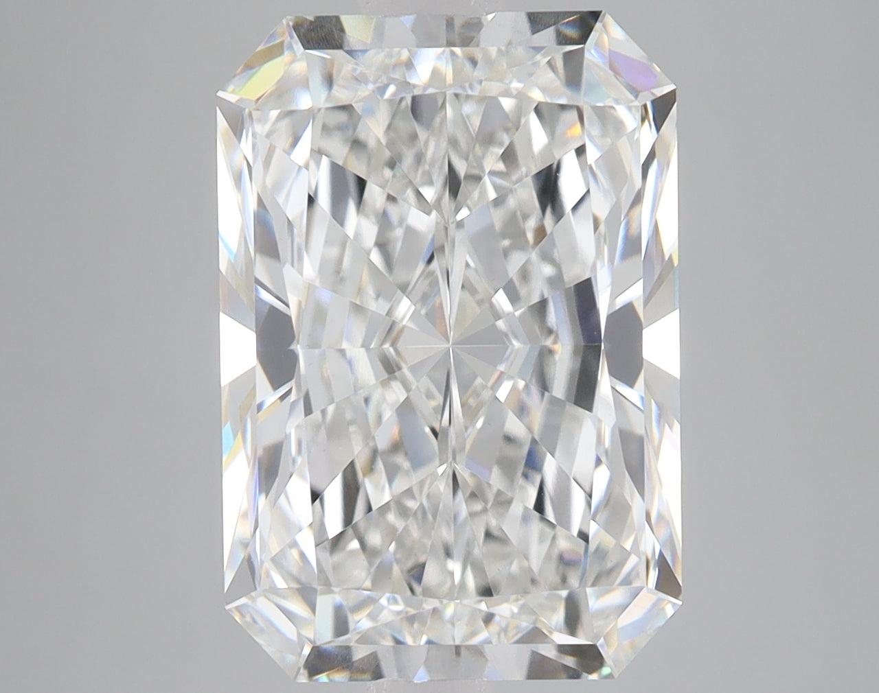 Colorless radiant-cut lab-grown diamond with multiple facets and light reflections on neutral background.