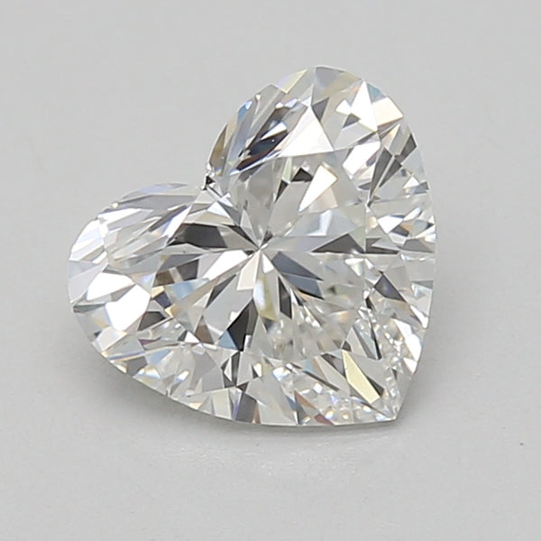 Heart-shaped lab-grown diamond with brilliant faceting and light reflections on neutral background.