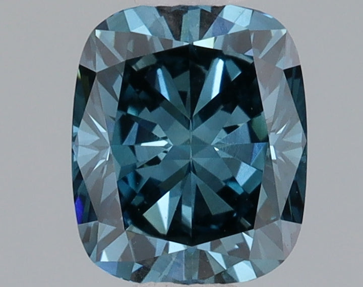 Cushion-cut lab-grown diamond with faceted surfaces displaying blue-tinted light reflections on neutral background.