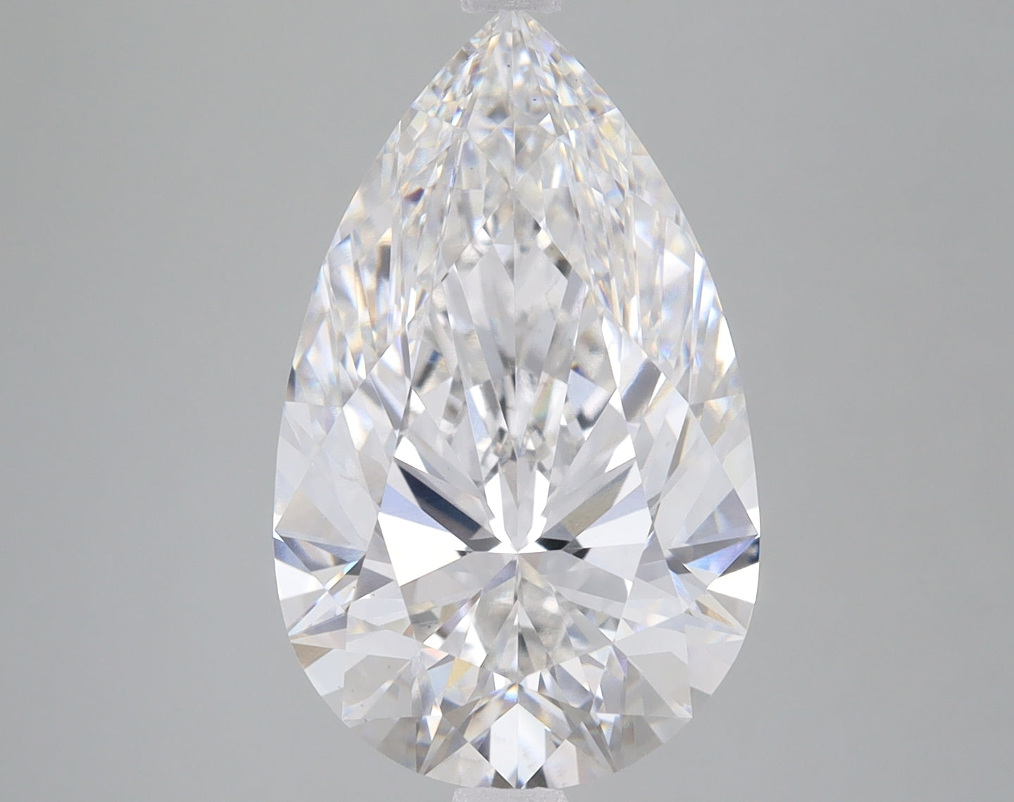 Pear-shaped lab-grown diamond with multiple facets displaying light refraction on gray background.