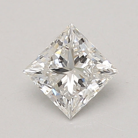 Clear princess-cut diamond with faceted surfaces and reflective light patterns on gray background.
