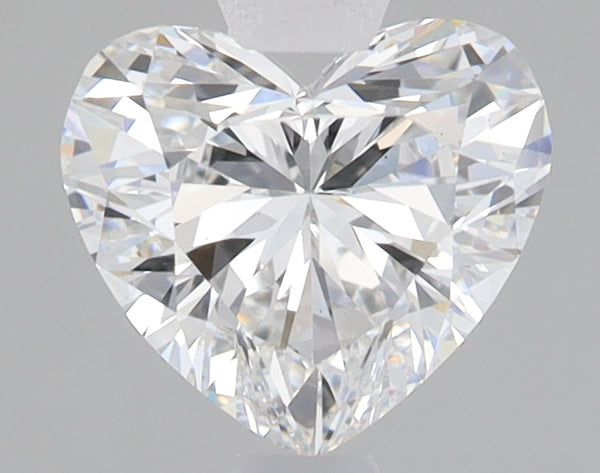 Heart-shaped lab-grown diamond with faceted surface and bright refractive properties on neutral background.