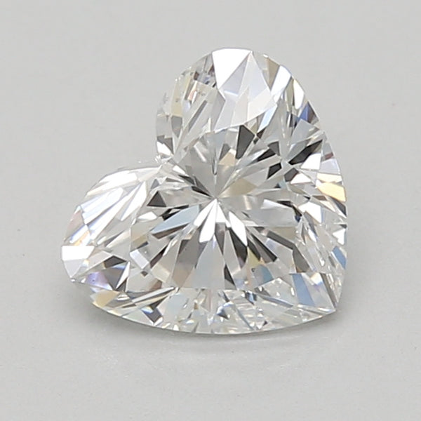 Heart-shaped lab grown diamond with faceted surface and colorless appearance, displayed on neutral background.