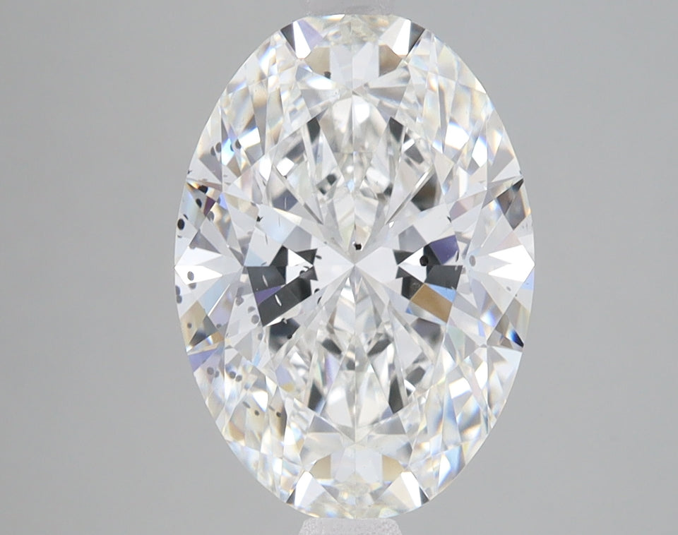Oval-cut lab-grown diamond with faceted surface reflecting light, displayed against neutral gray background.