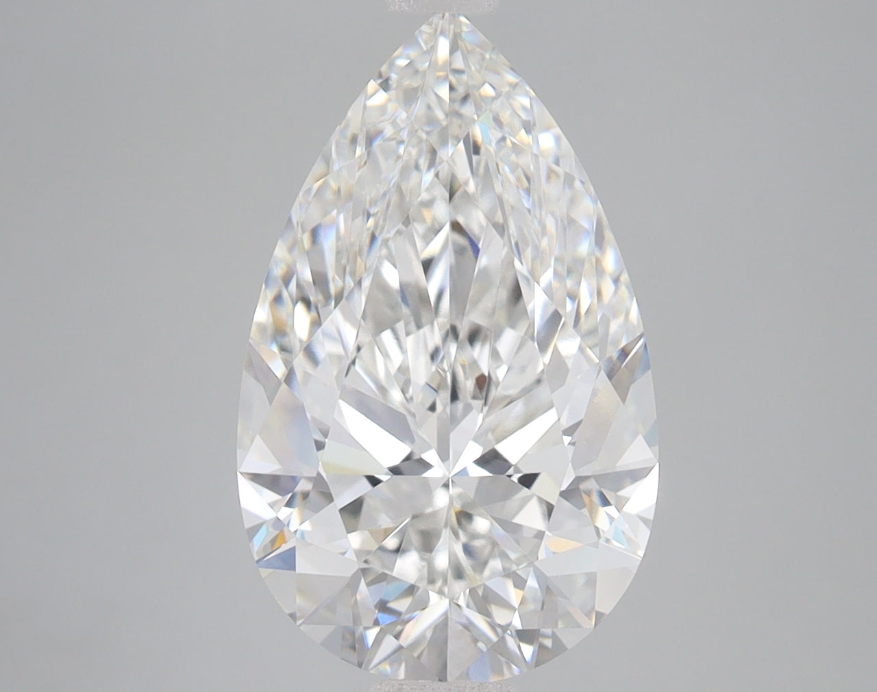 Pear-shaped lab-grown diamond with faceted surface and light refractions on neutral background.
