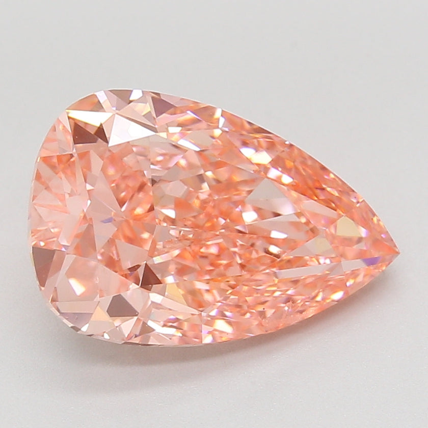 Pear-shaped lab-grown diamond with faceted surface and peachy-pink coloring, displayed on neutral background.