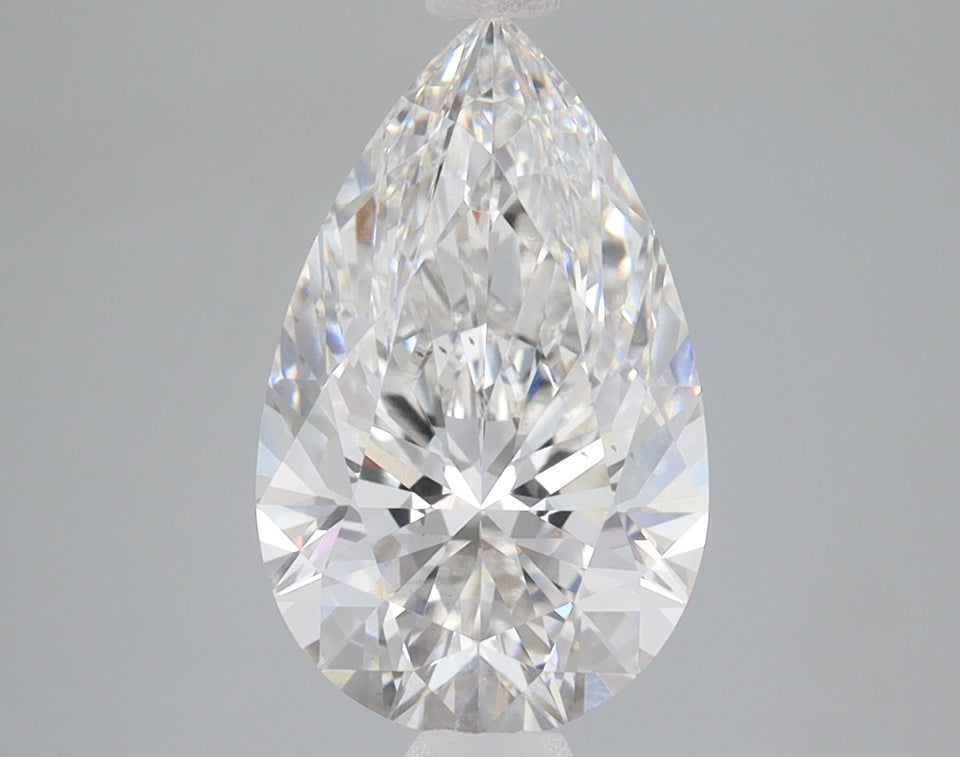 Pear-shaped lab-grown diamond with faceted surface displaying light refraction on neutral background.