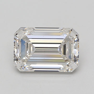 Emerald-cut colorless diamond with faceted sides and stepped table facet on gray background.