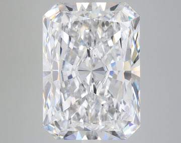 Radiant cut loose diamond with clear faceted surfaces and light reflections on gray background.