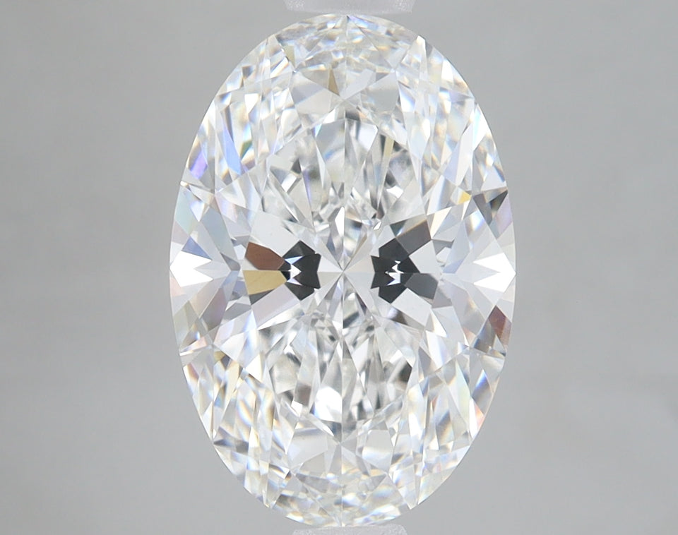Oval cut lab-grown diamond with faceted surface and light reflections on gray background.