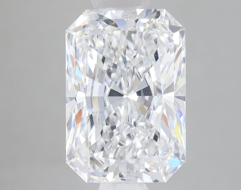 Radiant cut lab-grown diamond with clear faceted surface and light reflections on neutral background.