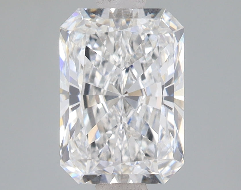 Clear radiant-cut diamond with faceted surfaces reflecting light, displayed on gray background.