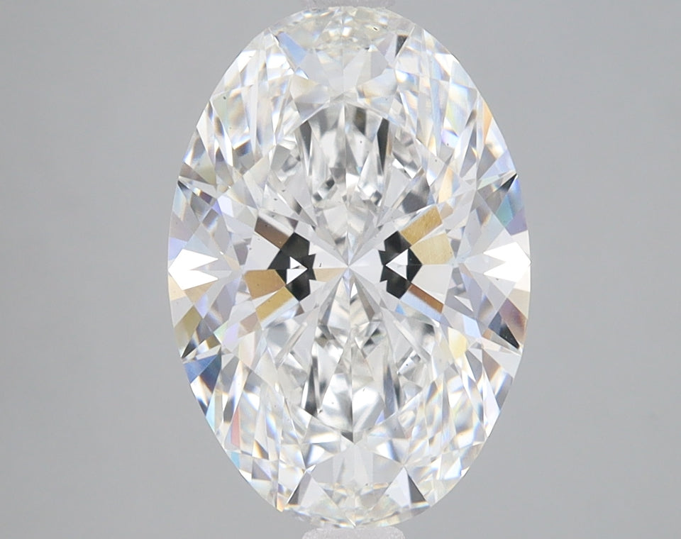 Oval-cut colorless diamond with faceted surface and light refraction visible throughout the stone.