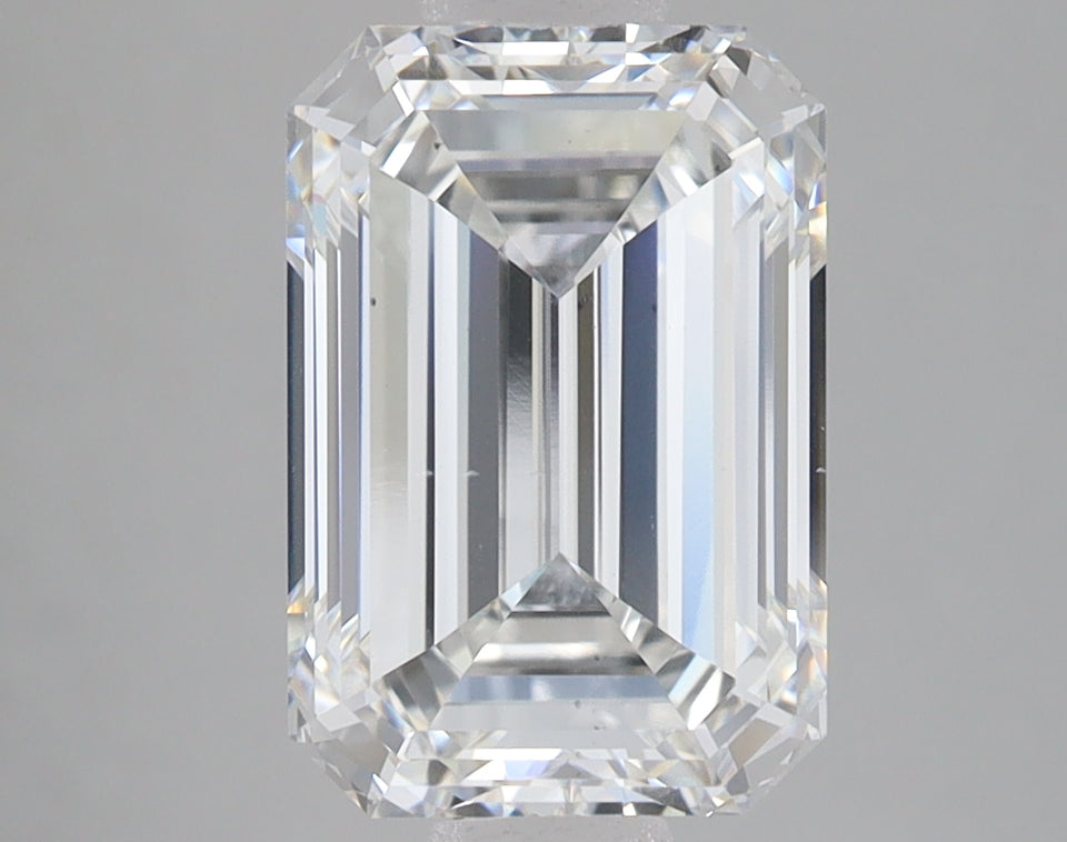 Emerald-cut lab-grown diamond with faceted sides and sharp corners, displaying clear sparkle and light refraction on neutral 