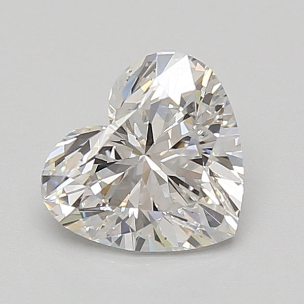 Heart-shaped lab-grown diamond with faceted surface reflecting light, displayed against neutral background.