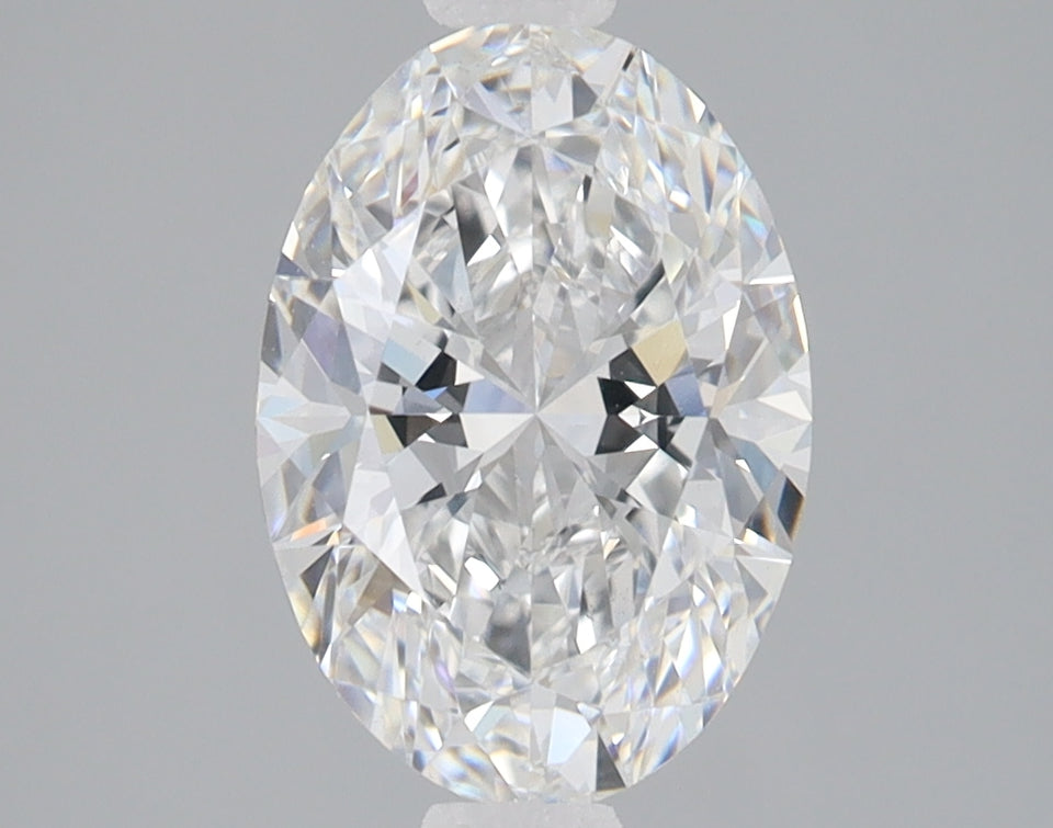 Oval-cut lab-grown diamond with faceted surface and light reflections on neutral gray background.