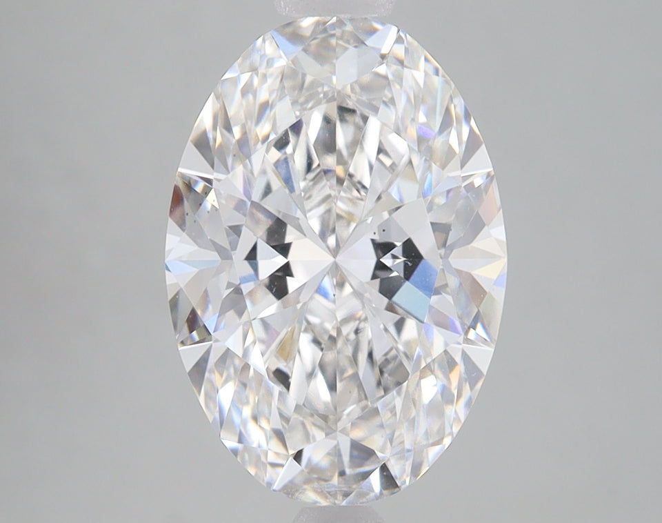 Oval-cut loose diamond with faceted surfaces reflecting light, displayed against a neutral gray background.