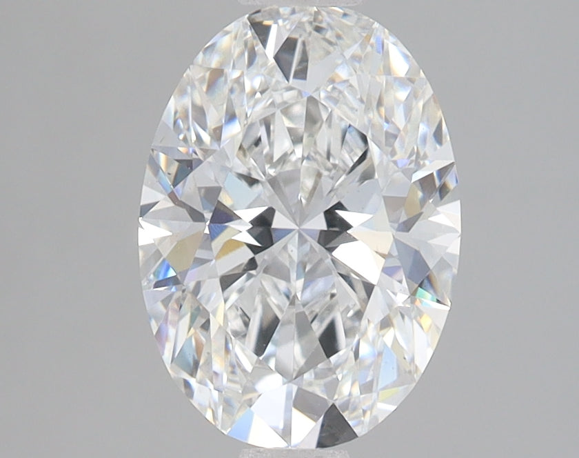 Oval-cut lab-grown diamond with faceted surfaces reflecting light, displayed against a neutral gray background.