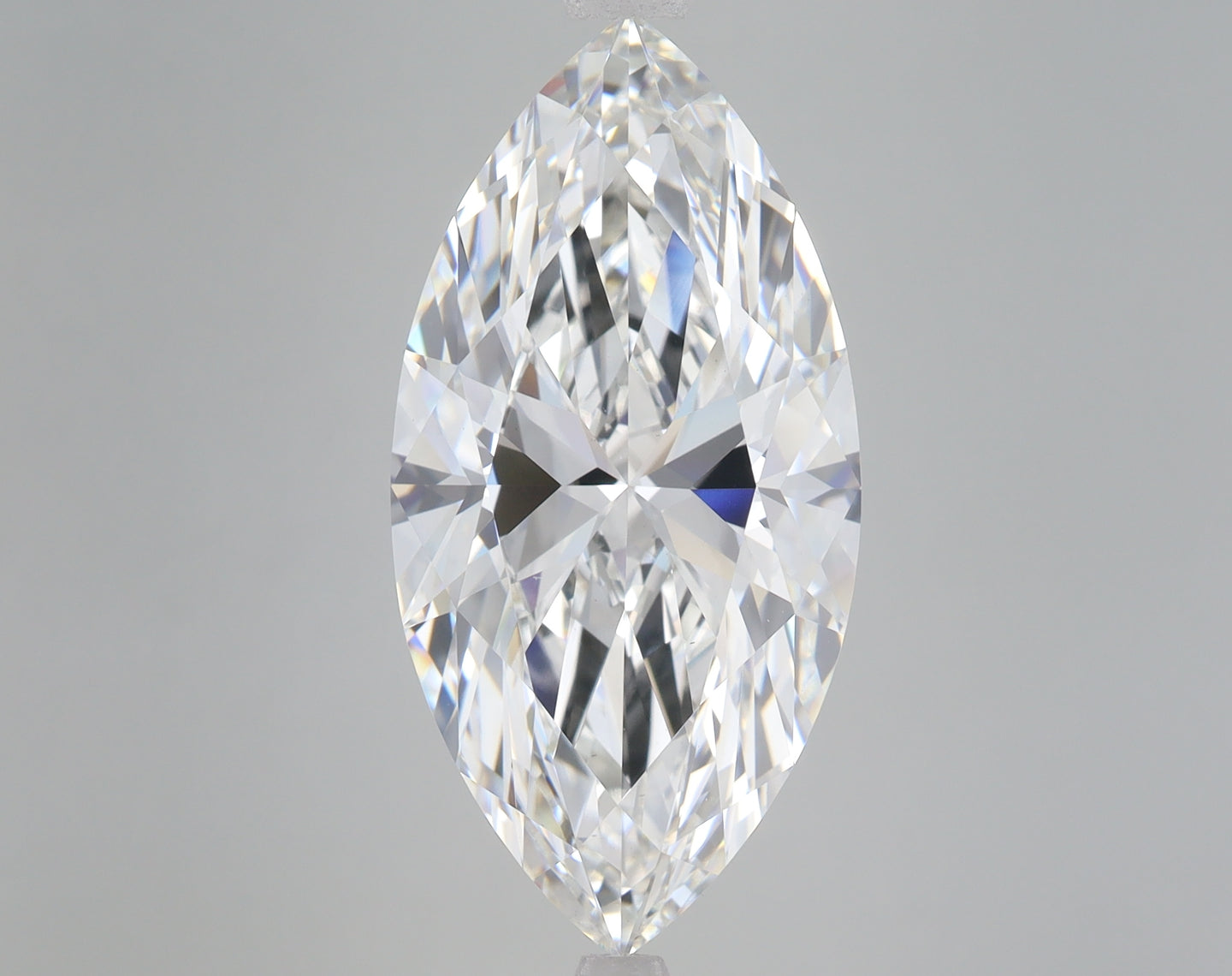 Marquise-cut lab-grown diamond with faceted surface displaying light refraction on gray background.