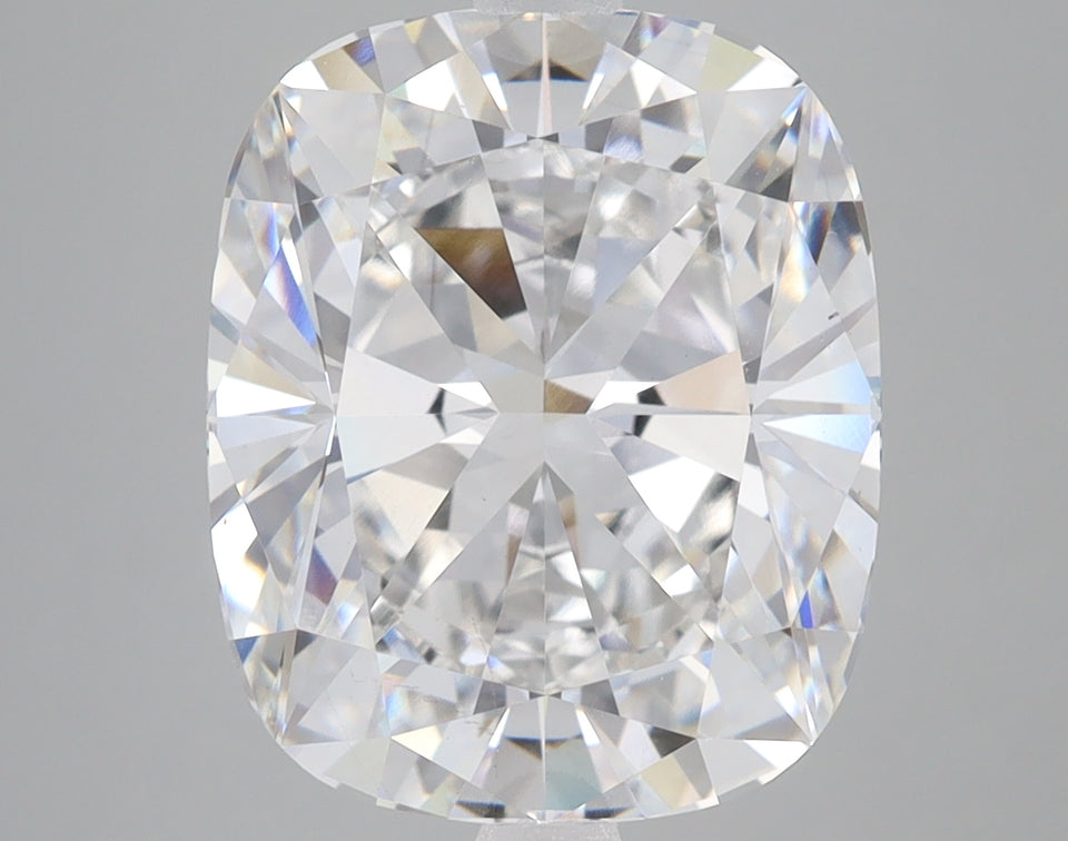 Cushion-cut lab-grown diamond with brilliant faceting and light refraction on gray background.