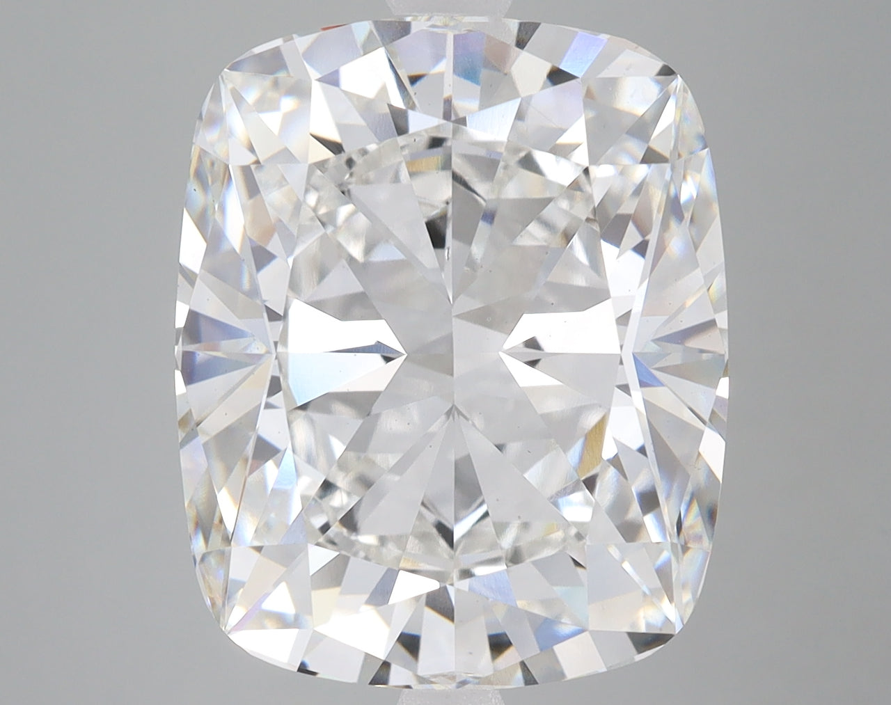 Cushion-cut colorless diamond with faceted surface reflecting light, displayed against gray background.
