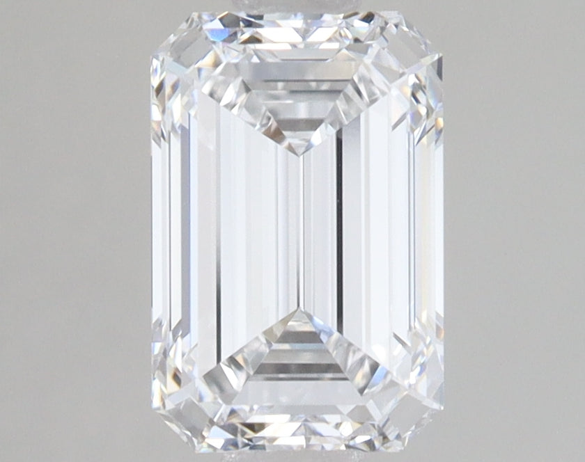Emerald-cut lab-grown diamond with faceted sides and clear appearance on neutral background.