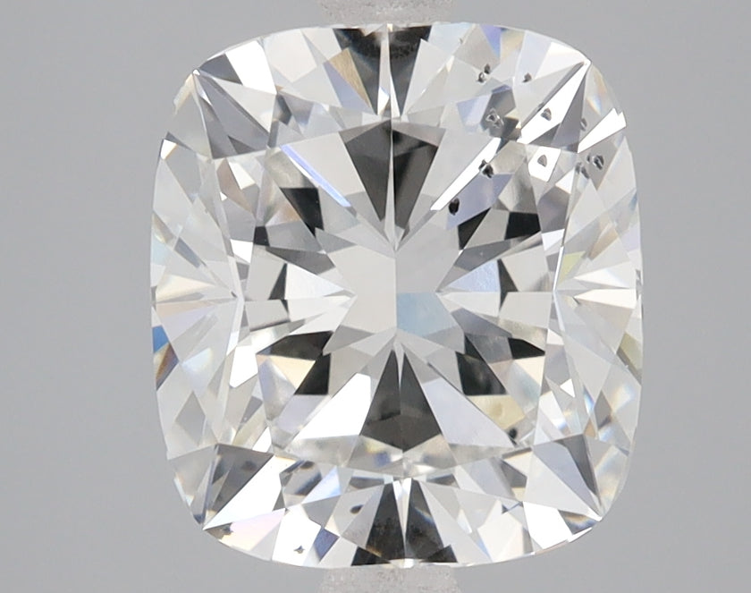 Cushion cut lab-grown diamond with brilliant faceting and light reflections on gray background.