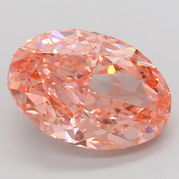 Oval-cut lab-grown diamond with peachy-pink hue and faceted surface, displaying light reflections on gray background.