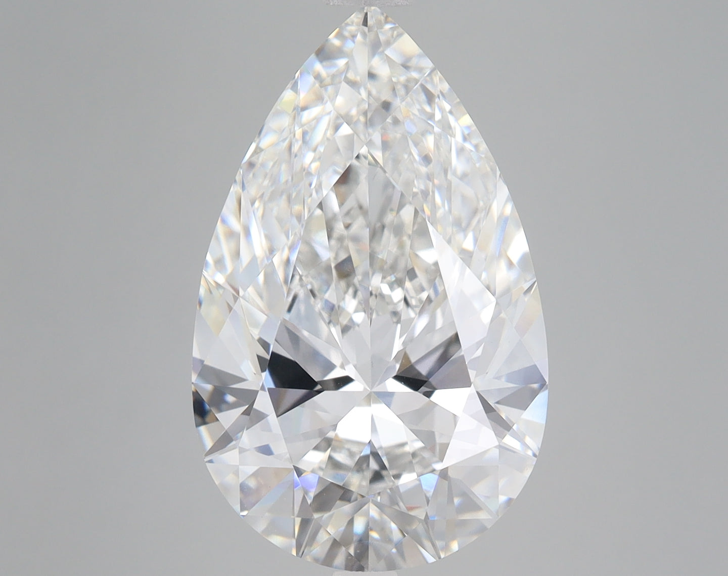 Pear-shaped lab-grown diamond with faceted surfaces and light refraction on gray background.