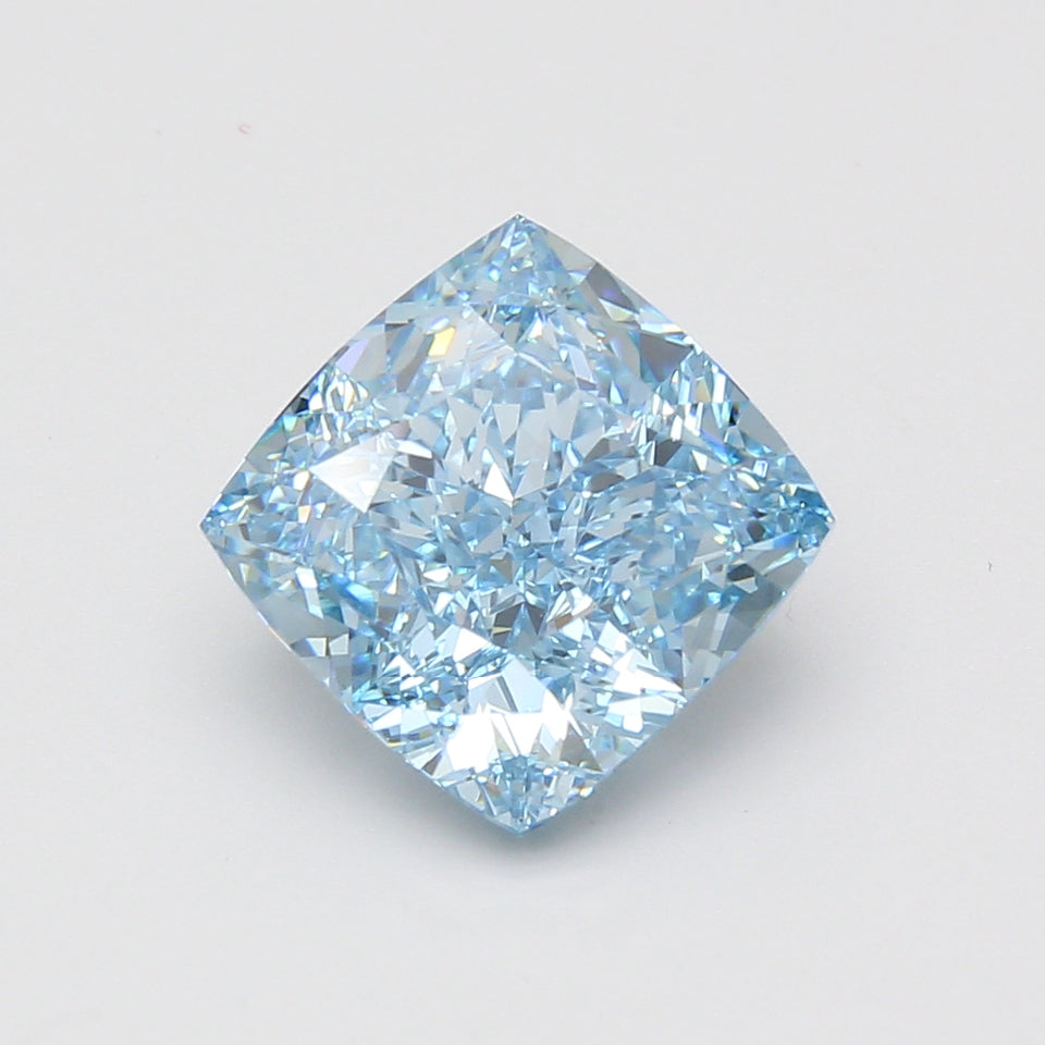 Cushion cut lab grown diamond with light blue tint, faceted surfaces reflecting light, displayed against neutral background.