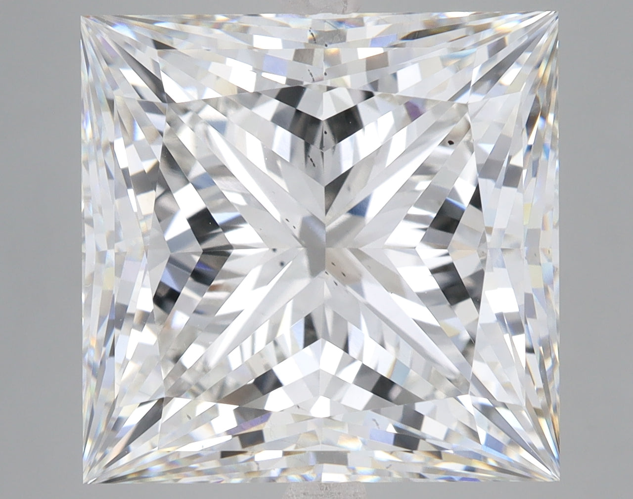 Princess-cut lab-grown diamond with faceted surface reflecting light, displayed against neutral background.