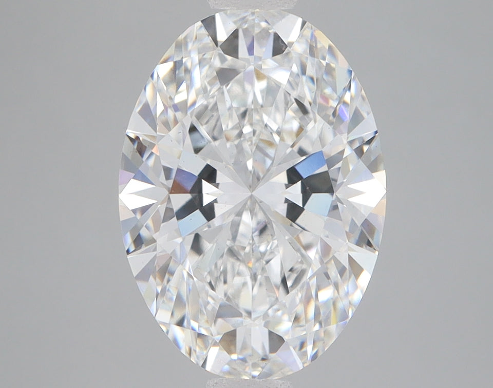 Oval-cut lab-grown diamond with faceted surfaces reflecting light, displayed against neutral gray background.