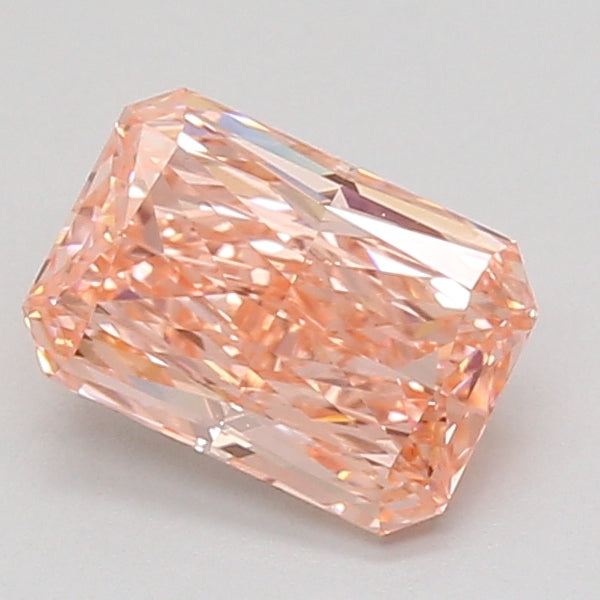 Radiant-cut loose diamond with peach-pink tone and faceted surface, displayed against neutral background.