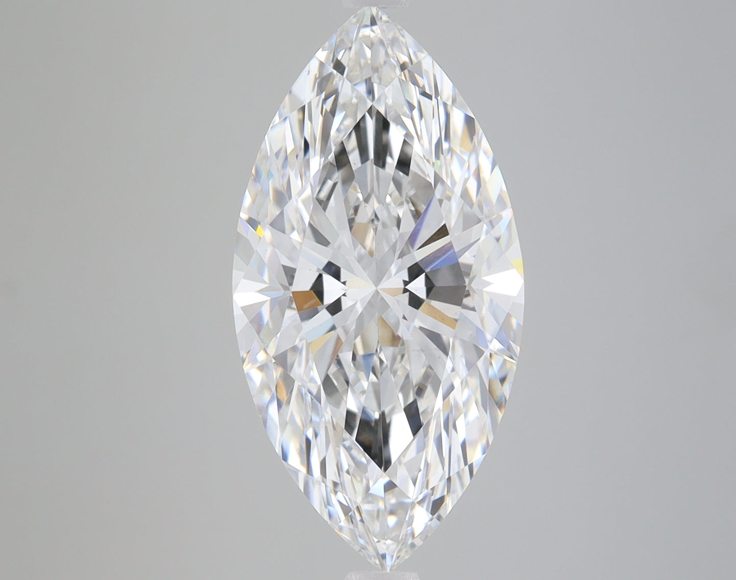 Colorless marquise-cut diamond with faceted surfaces and internal reflections on neutral gray background.