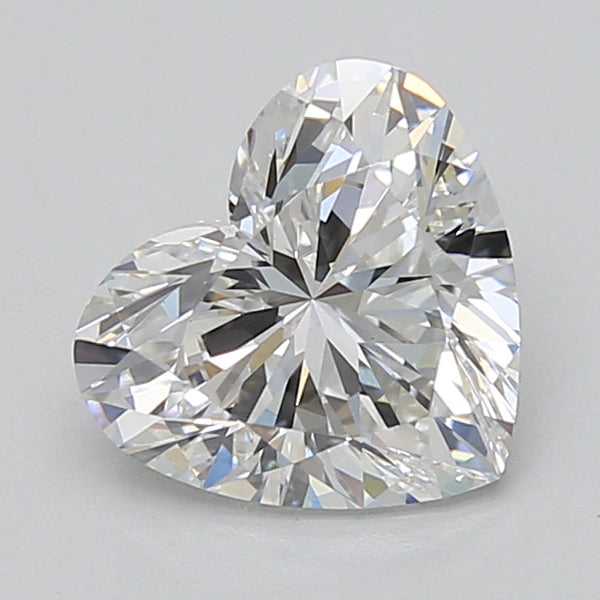 Heart-shaped lab-grown diamond with faceted cut and colorless appearance on neutral background.