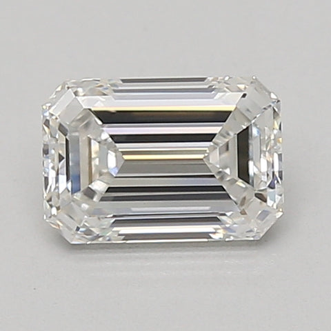 Emerald-cut lab-grown diamond with clear facets and reflective surfaces on neutral background.