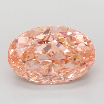 Oval lab-grown diamond with faceted cut and peachy-pink hue against neutral background.