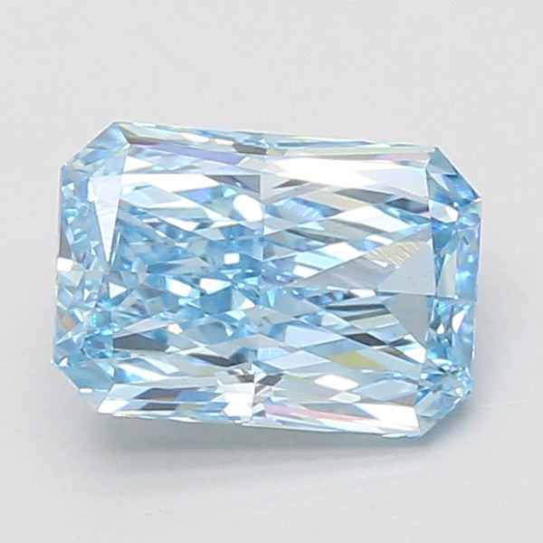 Radiant cut lab grown diamond with light blue hue and faceted surface reflecting light, displayed on neutral background.